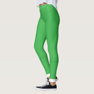 a green background with a white border leggings