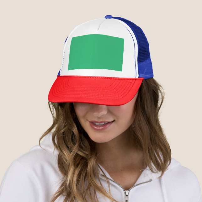 a green background with a white border trucker hat (In Situ)