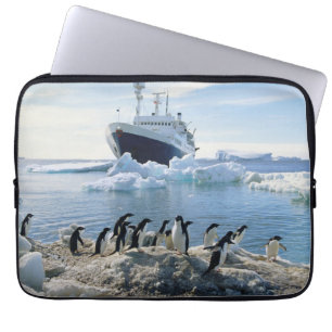 A Group Of Penguins Standing On An Icy Beach Laptop Sleeve