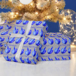A Hanukkah Dreidels Blue Pattern Personalise This Wrapping Paper<br><div class="desc">Dancing Dreidels in blue form a cheerful pattern on this Hanukkah wrapping paper perfect for kids or adults. Unwrap eight nights of Chanukah fun with bold colours of blue, white and silver with two spaces for your own text, which can also be deleted for Dreidel only gift wrap. Personalise each...</div>