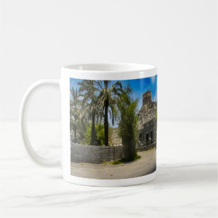 A historic Al Bidya Mosque landscape in the UAE Coffee Mug