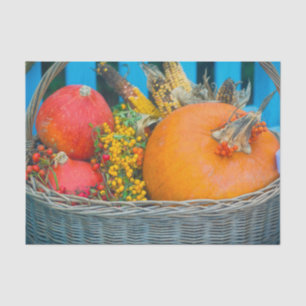 A holiday basket with pumpkins  tissue paper