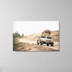 A Humvee conducts security Canvas Print