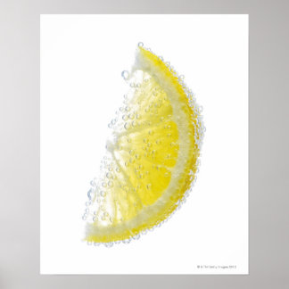 A juicy ripe organic lemon wedge fruit submerged poster