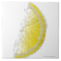 A juicy ripe organic lemon wedge fruit submerged