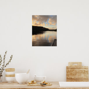 A lake at sunset mirroring the sky poster