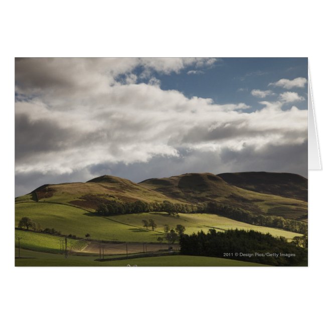 A Landscape With Rolling Hills And Clouds Overhead (Front Horizontal)