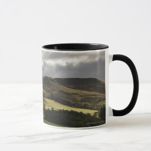 A Landscape With Rolling Hills And Clouds Overhead Mug