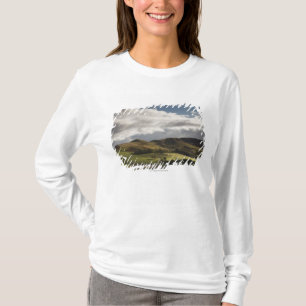 A Landscape With Rolling Hills And Clouds Overhead T-Shirt