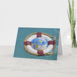 A life preserver and world globe floating card