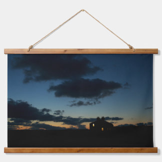 A lone house on the horizon at dusk. hanging tapestry
