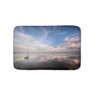 A Lone Sailboat On The Calm Waters Of Salton Bath Mat