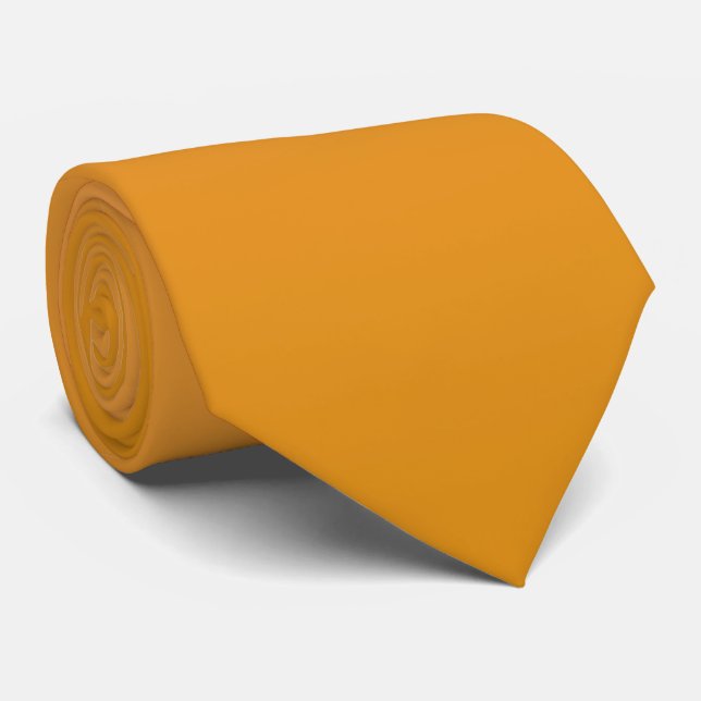 A long, solid mustard yellow necktie (Rolled)