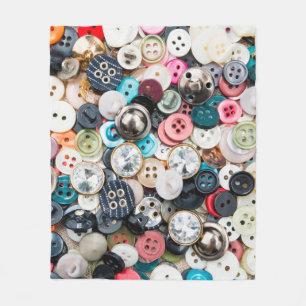 A lot of colourful sewing buttons of different col fleece blanket