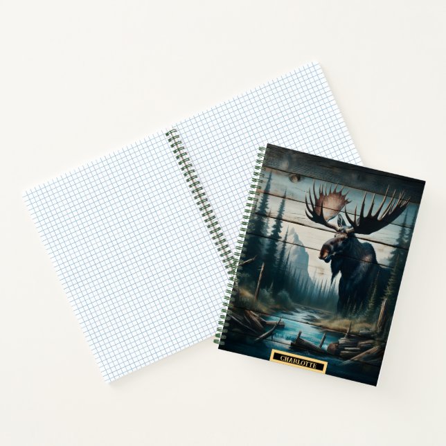 A majestic moose standing by a tranquil riverbank notebook (Inside)