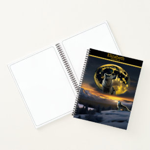 A majestic wolf howling at the glowing moonlit sky notebook