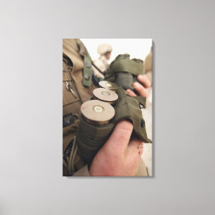 A Marine cradles handfuls of 40 mm grenades Canvas Print