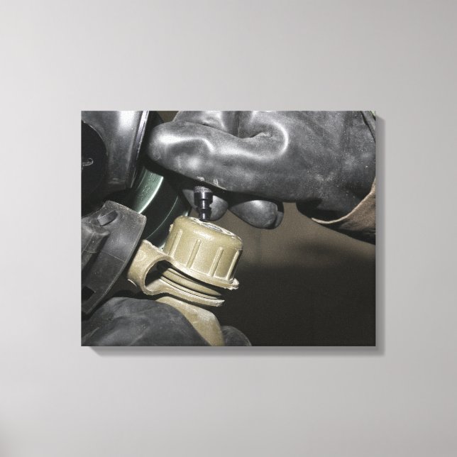 A Marine inserts a drinking tube into his cante Canvas Print (Front)