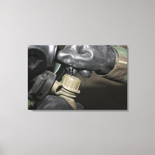 A Marine inserts a drinking tube into his cante Canvas Print