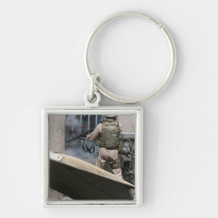 A military policeman uses a breaching round key ring