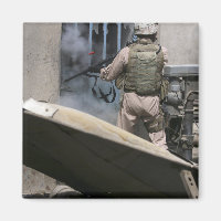 A military policeman uses a breaching round