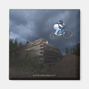 A mountain biker jumps off a log cabin in Idaho. Magnet