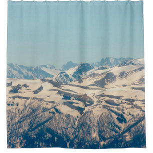 A mountain range with thawing snow and ice in the shower curtain
