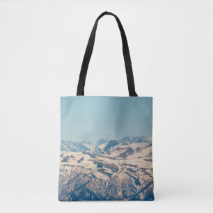 A mountain range with thawing snow and ice in the  tote bag
