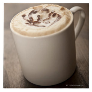 A mug of Cappuccino coffee topped with melted Tile