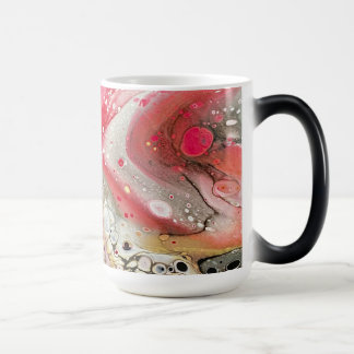 A mug with pink, gold, and black colors