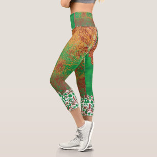 a painting of a green field with an orange border capri leggings