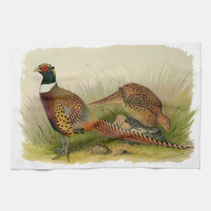A pair of Ring necked pheasants in a grassy field Tea Towel