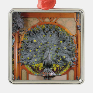 A peacock from the central panel of a mural metal tree decoration