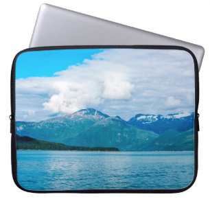 A peninsula of land covered in pine forest juts ou laptop sleeve