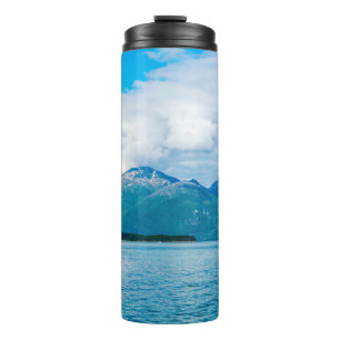 A peninsula of land covered in pine forest juts ou thermal tumbler