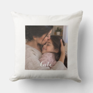 A picture of a mother kissing her young daughter cushion