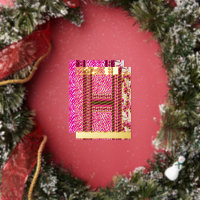 a pink and white wallpaper with a cross on it