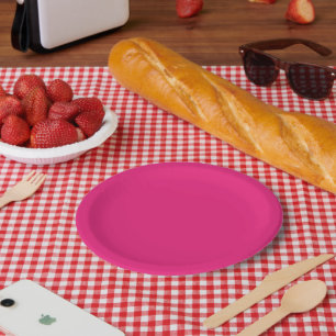 a pink background with a black border paper plate
