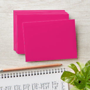 a pink background with a black envelope