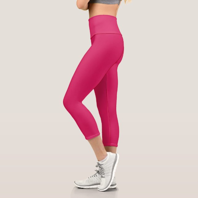 a pink background with a white border capri leggings (Left)