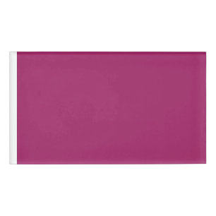 a pink background with a white border name tag