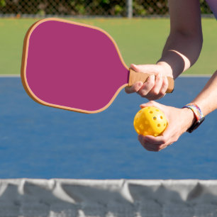 a pink background with a white border pickleball paddle
