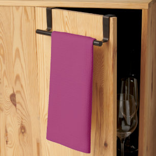 a pink background with a white tea towel