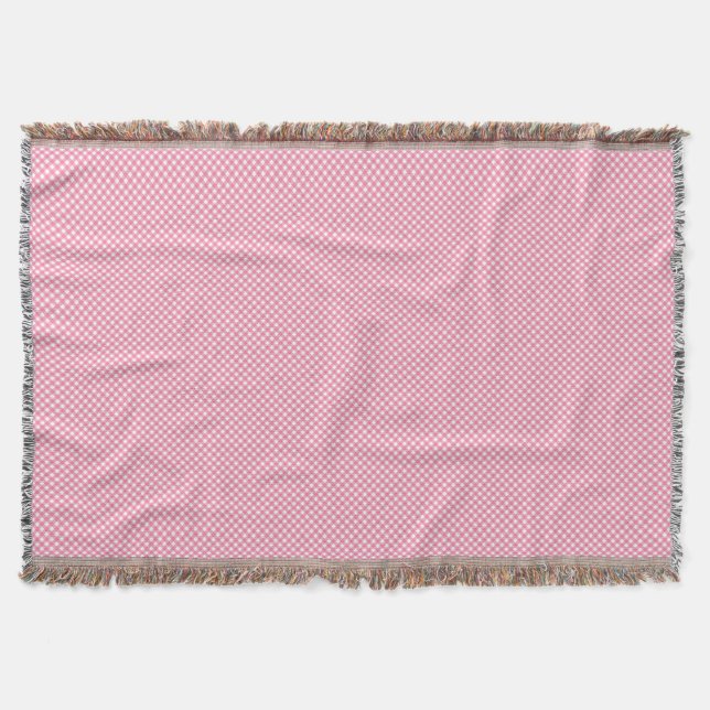 A pink woven blanket with a subtle pattern  (Front)