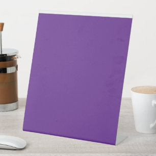 a purple background with a white border pedestal sign