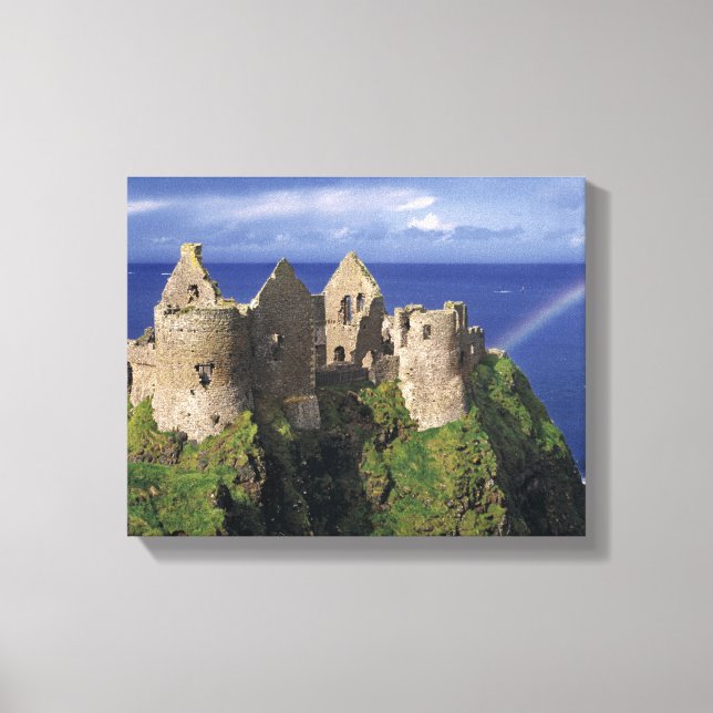 A rainbow strikes mediaeval Dunluce Castle on Canvas Print (Front)