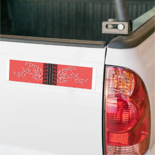 a red and black pattern with flowers on it bumper sticker