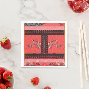 a red and black pattern with flowers on it napkin
