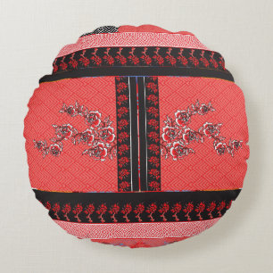 a red and black pattern with flowers on it round cushion