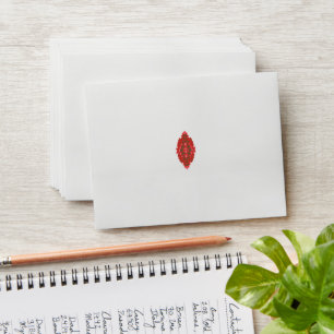 a red and brown design on a white background envelope